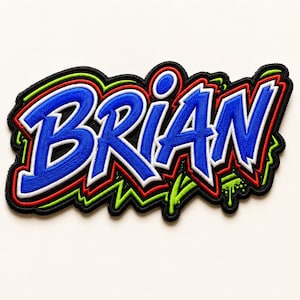 May include: An embroidered patch featuring the name BRIAN in bold blue letters with white outlines. The design includes a black background, red and bright green accents, and a graffiti-inspired style with a drip effect on the letter N.