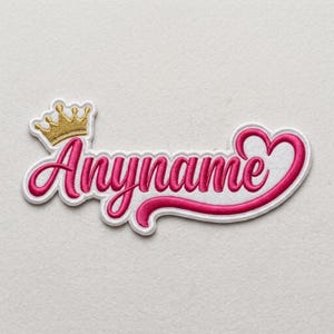 May include: Embroidered patch featuring the word "Anyname" in a cursive font, outlined in white, with a pink fill. A gold crown sits above the name, and a heart shape is integrated into the design. The patch is on a white background.