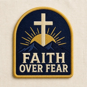 May include: An arched embroidered patch featuring a dark blue background with a cream-colored cross centered over a yellow sunburst and dark blue mountain silhouettes. The text FAITH OVER FEAR is stitched in cream letters at the bottom with a gold border.