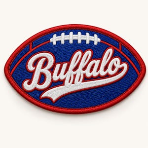 May include: Embroidered patch in the shape of a football, featuring the word "Buffalo" in white script. The patch has a blue background with white stitching and a red border.
