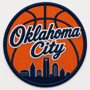 May include: A circular embroidered patch featuring an orange basketball background with dark blue stitching. The text Oklahoma City is embroidered in a white-outlined dark blue script font. A dark blue city skyline silhouette sits below the text.