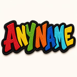 May include: Embroidered patch with the word "ANYNAME" in a colorful, bubble-style font. The letters are red, yellow, green, orange, blue, and yellow, outlined in black. This patch is designed to be ironed on or sewn onto fabric.