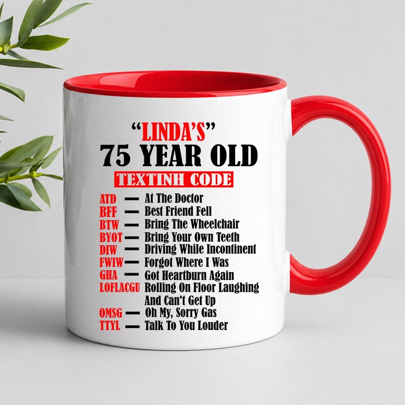 May include: A white ceramic mug with a red interior and handle. The mug features the text "LINDA'S" and "75 YEAR OLD" in black, with a list of acronyms and their meanings below. A humorous gift.