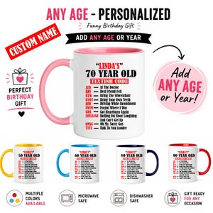 May include: White ceramic mug with a pink handle and rim, featuring the text "LINDA'S 70 YEAR OLD" and a list of humorous text message abbreviations. Additional mugs in yellow, blue, navy, and red are shown, each with a different age.