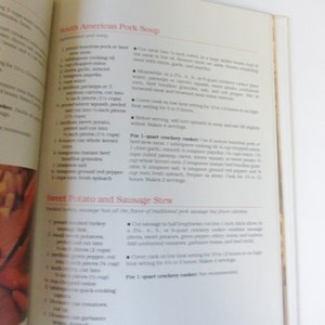 May include: A cookbook page with recipes for South American Pork Soup and Sweet Potato and Sausage Stew. The recipes include ingredients and instructions for preparing the dishes in a crockpot.
