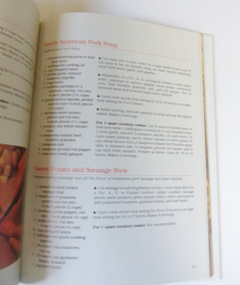 May include: A cookbook page with recipes for South American Pork Soup and Sweet Potato and Sausage Stew. The recipes include ingredients and instructions for preparing the dishes in a crockpot.