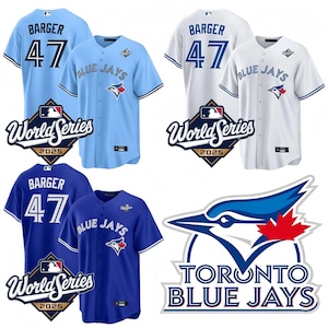May include: Three Toronto Blue Jays baseball shirts in light blue, white, and blue. Each shirt has the name "BARGER" and the number "47". The "World Series 2025" logo is displayed on each shirt. The Blue Jays logo is also visible.