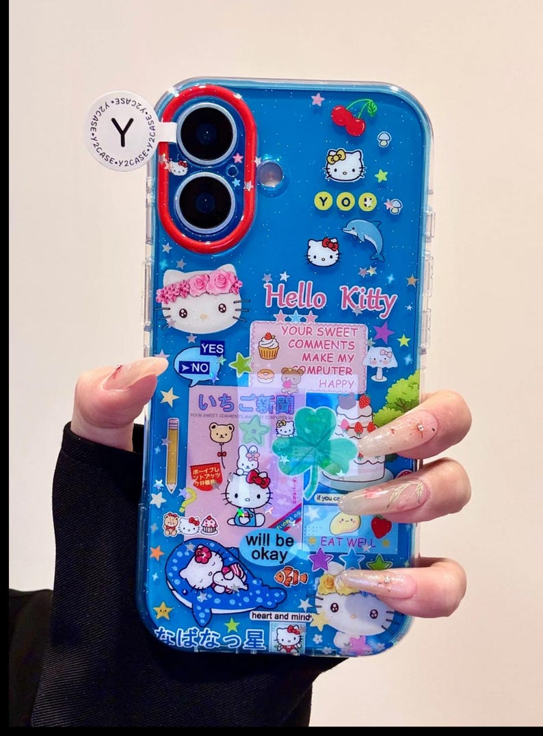 May include: Blue phone case with a Hello Kitty theme. The case features various Hello Kitty designs, stars, and text. The text includes "Hello Kitty", "Your sweet comments make my computer happy", and "will be okay".