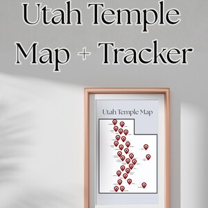 May include: A framed Utah Temple Map + Tracker print. The map of Utah is outlined in black with red pin markers indicating temple locations. The frame is a light brown color, and the text "Utah Temple Map + Tracker" is above the framed print.