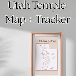May include: A framed Utah Temple Map + Tracker print. The map features a detailed outline of Utah with temple locations marked by peach-colored pins. The frame is a light brown color, and the text "Utah Temple Map + Tracker" is displayed above the frame.