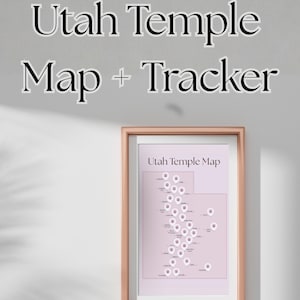 May include: A framed Utah Temple Map + Tracker print. The map is in a light pink color, with white pin markers. The frame is a light brown color. The text "Utah Temple Map + Tracker" is above the frame.