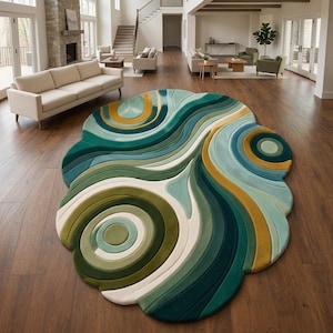 May include: An irregular, organic-shaped area rug featuring a layered, three-dimensional design with concentric circles and flowing, wave-like patterns in shades of deep forest green, teal, light mint, mustard yellow, and creamy off-white.