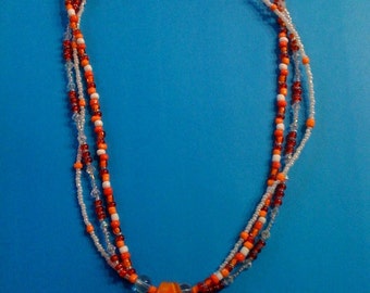 Orange tones with orange glass pendant Necklace 20 inch triple strand