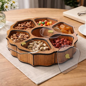 May include: A wooden serving tray with multiple compartments, filled with various snacks like nuts and candies. The tray has a unique, scalloped edge design and includes clear, circular lids. The tray is set on a neutral-colored placemat.