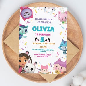 May include: A rectangular birthday invitation card featuring colorful cartoon cat characters and sprinkles on a white background. The text reads: PLEASE JOIN US TO CELEBRATION OLIVIA IS TURNING 5 MONDAY, 25 DECEMBER AT 6PM 123 ANYWHERE, ANY CITY, ST 1245 RSVP TO KATE-LYN AT 987-654-3210.