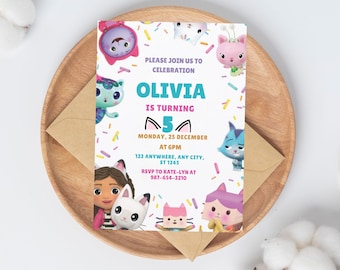 May include: A rectangular birthday invitation card featuring colorful cartoon cat characters and sprinkles on a white background. The text reads: PLEASE JOIN US TO CELEBRATION OLIVIA IS TURNING 5 MONDAY, 25 DECEMBER AT 6PM 123 ANYWHERE, ANY CITY, ST 1245 RSVP TO KATE-LYN AT 987-654-3210.
