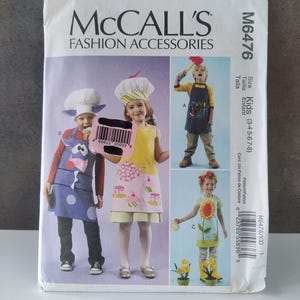 May include: McCall's Fashion Accessories sewing pattern for kids' aprons and chef hats. The pattern includes designs for aprons with various themes, such as a cow, a chef, and a sunflower. The pattern is for sizes 3-4, 5-6, and 7-8.