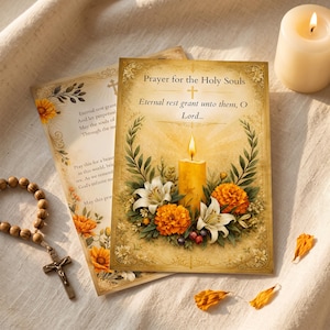 May include: A rectangular prayer card titled Prayer for the Holy Souls featuring a central yellow candle, white lilies, and orange marigolds. The text reads Eternal rest grant unto them, O Lord. A wooden rosary with a crucifix lies to the left.