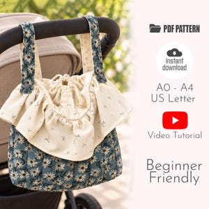 May include: A quilted bag with a blue floral pattern and a cream-coloured ruffled top featuring a small floral print. The bag has two straps with dark buttons and a drawstring closure. Text includes PDF PATTERN, instant download, AO - A4 US Letter, Video Tutorial, and Beginner Friendly.