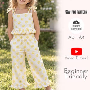 May include: A two-piece outfit featuring a white sleeveless top with yellow floral patterns, tie-shoulder straps, and a ruffled hem, paired with matching wide-leg pants with a ruffled hem. Text includes PDF PATTERN, instant download, A0-A4, Video Tutorial, Beginner Friendly.