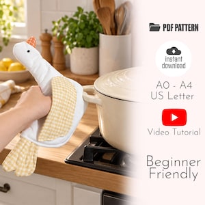 May include: A white fabric oven mitt shaped like a goose with a yellow and white gingham patterned wing and tail. The text includes PDF PATTERN, instant download, AO - A4 US Letter, Video Tutorial, and Beginner Friendly.