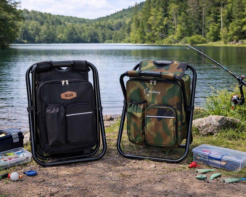 May include: Two portable folding chairs with integrated backpacks, one in solid black and one in a camouflage pattern. The black chair features a brown leather-like patch labeled William, while the camouflage chair displays the name Anthony.