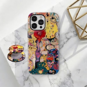 May include: A phone case and matching phone grip with a vibrant, abstract design inspired by Gustav Klimt's art. The case is multi-coloured with gold, red, and blue tones. The phone grip has a similar design.