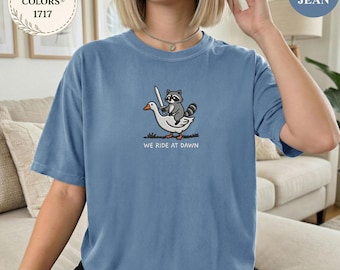 We Ride At Dawn Shirt, Funny Raccoon Riding Goose Tee, Cute Animal Shirt, Meme T Shirt, Fantasy Raccoon Gift, Comfort Colors 1717