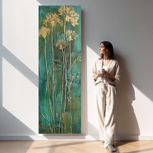 Pode incluir: Pintura abstrata retangular com fundo turquesa texturizado e detalhes florais dourados. A obra apresenta vários caules e flores douradas estilizadas. A pintura é exibida contra uma parede branca.