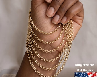 May include: A gold-toned rolo chain necklace featuring multiple circular links arranged in a cascading, layered formation. The chain has a polished, reflective surface and a consistent, uniform link pattern throughout its entire length.
