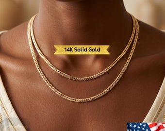 May include: Two gold-colored necklaces with a curb chain design are displayed. The necklaces are layered, with one slightly longer than the other. The text "14K Solid Gold" is displayed on a gold banner above the necklaces.