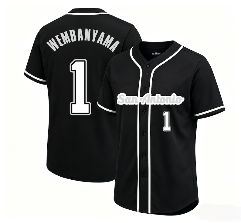 May include: Black baseball jersey with white trim and the number 1. The jersey has "WEMBANYAMA" on the back and "San Antonio" on the front. The jersey is button-down with short sleeves.