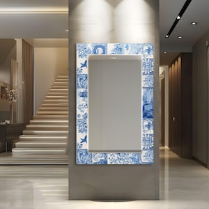 May include: A rectangular wall mirror featuring a decorative frame composed of blue and white ceramic tiles. Each tile displays intricate illustrations of landscapes, architectural structures, and floral motifs, creating a cohesive border around the glass.