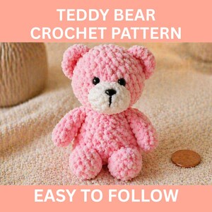 May include: A pink crocheted teddy bear with a white muzzle and black eyes. The text "TEDDY BEAR CROCHET PATTERN" and "EASY TO FOLLOW" are displayed above and below the bear. A penny is next to the bear.