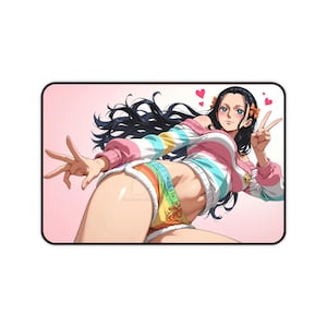 May include: A rectangular mousepad featuring a colorful anime-style illustration of a character in a striped sweater and rainbow shorts. The character has long black hair and is making a peace sign.