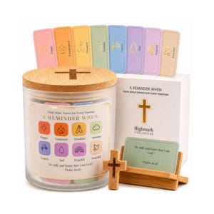 May include: A glass jar with a wooden lid and a cross-shaped cutout, filled with colorful cards. The jar is labeled "A Reminder When" with various emotions. A wooden cross and a card holder with a Bible verse are also present.