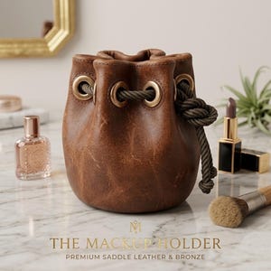 May include: A white ceramic mug with a black handle and the text "But First, Coffee" in a black, handwritten-style font. The mug is on a white surface.