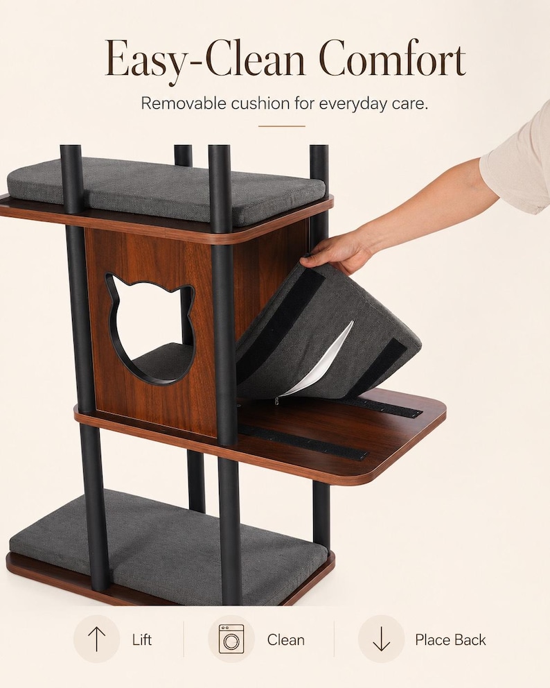 May include: A multi-level cat tree with dark wood-grain platforms and black metal supports. It features a cat-shaped cutout and removable gray fabric cushions with velcro attachments. Text on the image reads Easy-Clean Comfort, Lift, Clean, and Place Back.