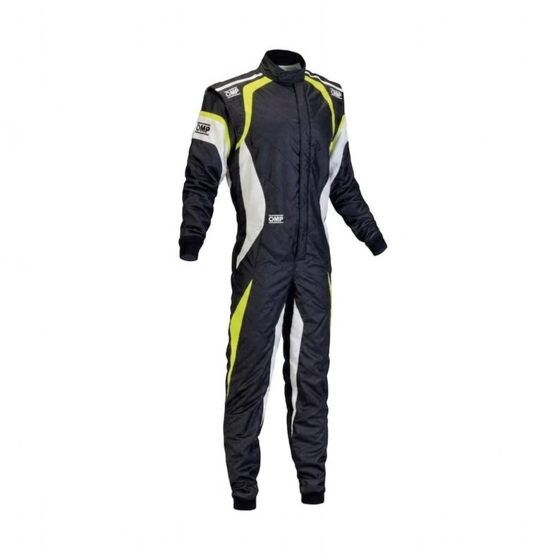 May include: A black racing suit featuring white and neon yellow side panels and accents. The garment includes a high collar, long sleeves with fitted cuffs, and the OMP logo printed in white on the chest and shoulders, providing a full-body design.
