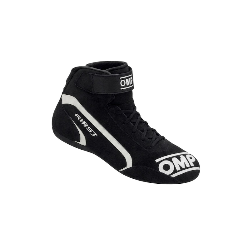 May include: A black high-top racing shoe featuring white OMP branding on the toe and ankle strap, with the word FIRST printed in white along the side. The shoe has a lace-up closure, a secure hook-and-loop ankle strap, and white accent lines.
