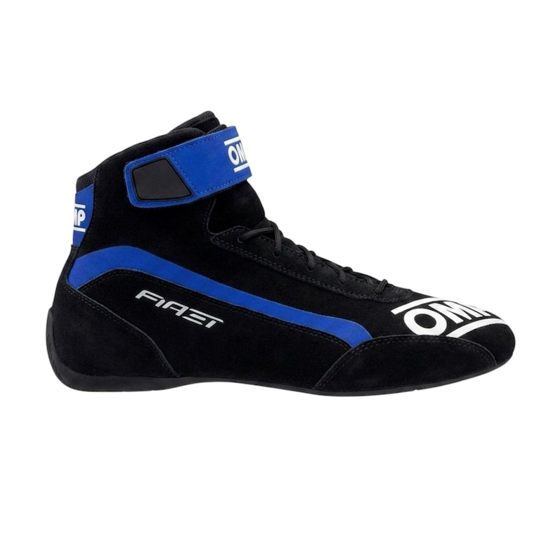 May include: Black and blue high-top racing shoe. The shoe features a black suede upper with blue accents, including a stripe and a velcro strap. The brand name "OMP" is visible in white.