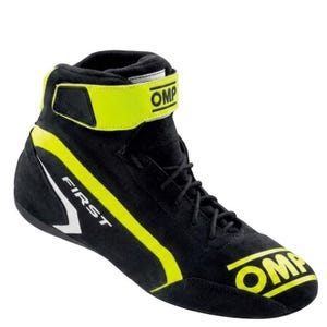 May include: A black high-top racing shoe featuring bright yellow accents, black laces, and a yellow ankle strap with the OMP logo. The word FIRST is printed in white on the side, and the OMP logo is printed in yellow on the toe area.