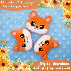 May include: Three orange and white fox plushies with black eyes and embroidered details. The plushies are arranged on a blue background with white hearts. The image includes text that reads "ITH - In The Hoop Embroidery pattern" and "Digital download".