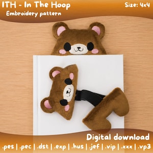 May include: A brown bear-shaped bookmark with pink inner ears and black eyes and nose, placed on a white book. The text "ITH - In The Hoop Embroidery pattern" and "Digital download" are visible. The size is 4x4.