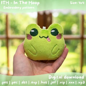 May include: A plush green frog with large black eyes, pink cheeks, and a small pink tongue sticking out. The frog is an embroidery pattern, as indicated by the text "ITH - In The Hoop Embroidery pattern" and "Size: 4x4". The image also includes the text "Digital download".