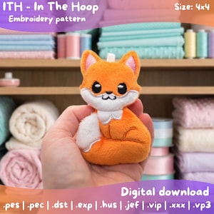 May include: A plush orange fox with white accents and black eyes is held in a hand. The image includes text that reads "ITH - In The Hoop Embroidery pattern" and "Digital download". The size is 4x4.