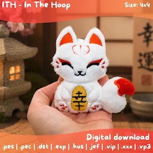 May include: A white plush fox toy with orange accents on the ears and tail, featuring embroidered red markings on the face and a gold oval patch on the chest with the black kanji character for luck. The design is labelled as ITH - In The Hoop, 4x4.