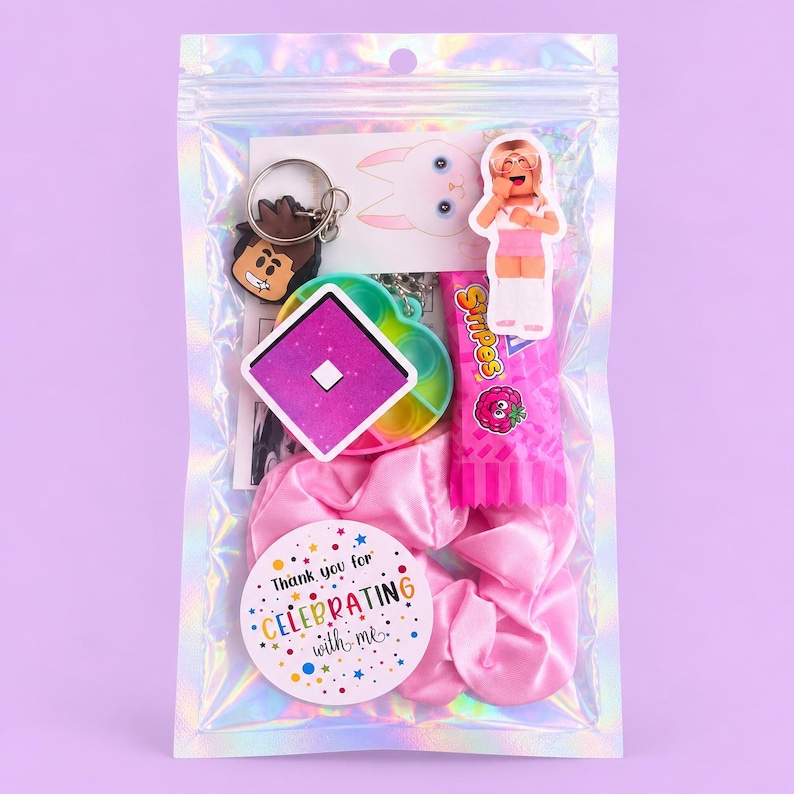May include: A clear iridescent plastic pouch containing a brown cartoon character keychain, a square purple and white logo sticker, a small character sticker, a pink candy wrapper, and a pink satin scrunchie with a round tag reading Thank you for CELEBRATING with me.