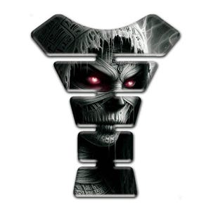 May include: A black and white motorcycle tank protector decal featuring a detailed illustration of a mummy with glowing red eyes. The design is segmented into horizontal sections with intricate wrappings and ancient Egyptian-style patterns.
