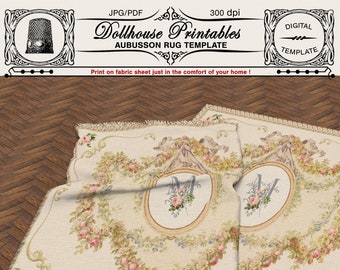 May include: Two printable Aubusson rug templates featuring a floral design with a monogram in the center. The rug templates are printed on a cream background with pink, green, and blue accents. The text "Dollhouse Printables" and "Aubusson Rug Template" is printed at the top of the image.